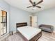 Bedroom with ceiling fan, window with natural light, and a comfortable seating area at 7803 Mathern Ct, Lakewood Ranch, FL 34202