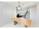 Sunlit dining area showcasing a stylish chandelier, tile floors, and connection to the living space at 7803 Mathern Ct, Lakewood Ranch, FL 34202