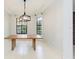 Bright dining room featuring large windows, modern light fixture, and tile flooring at 7803 Mathern Ct, Lakewood Ranch, FL 34202
