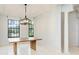 Dining area with natural lighting, sleek chandelier, and neutral finishes at 7803 Mathern Ct, Lakewood Ranch, FL 34202