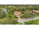 An inviting luxury home featuring a tile roof, elegant columns, and mature landscaping in an established community at 7803 Mathern Ct, Lakewood Ranch, FL 34202