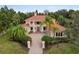 Elegant home featuring a red tile roof, manicured landscaping, and a brick driveway leading to the front entrance at 7803 Mathern Ct, Lakewood Ranch, FL 34202