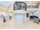 Grand foyer with wrought iron staircase and chandelier, open to living area and kitchen at 7803 Mathern Ct, Lakewood Ranch, FL 34202