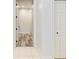 Hallway with tile and wood flooring leading to various rooms at 7803 Mathern Ct, Lakewood Ranch, FL 34202