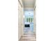 Hallway view of the primary bedroom featuring a large window with a view of the lanai at 7803 Mathern Ct, Lakewood Ranch, FL 34202