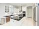 Modern kitchen with white cabinetry, stainless steel appliances, and black countertops at 7803 Mathern Ct, Lakewood Ranch, FL 34202