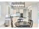 Bright kitchen with white cabinetry, stainless steel appliances, and modern hanging light fixture at 7803 Mathern Ct, Lakewood Ranch, FL 34202