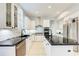 Spacious kitchen boasts white cabinets, black countertops, and stainless steel appliances at 7803 Mathern Ct, Lakewood Ranch, FL 34202