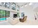 Bright living room with soaring ceilings, modern furniture, and sliding glass doors to the pool area at 7803 Mathern Ct, Lakewood Ranch, FL 34202
