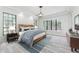 Serene main bedroom with wood floors, natural light, and cozy blue accents at 7803 Mathern Ct, Lakewood Ranch, FL 34202