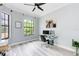 Bright office featuring a glass desk, modern lighting, and a large window at 7803 Mathern Ct, Lakewood Ranch, FL 34202