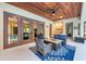 Relaxing outdoor living space with comfortable seating, a Tiki bar, and a cozy fire table at 7803 Mathern Ct, Lakewood Ranch, FL 34202