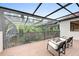 A screened-in patio with furniture and a view of the backyard at 7803 Mathern Ct, Lakewood Ranch, FL 34202