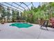 Gorgeous screened pool with chairs, hot tub and tropical landscaping for ultimate backyard enjoyment at 7803 Mathern Ct, Lakewood Ranch, FL 34202