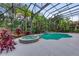 Beautiful screened-in pool and spa, nestled among lush landscaping and offering a private oasis at 7803 Mathern Ct, Lakewood Ranch, FL 34202