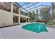 Wonderful backyard with screened-in pool and hot tub, surrounded by a spacious deck and lush greenery at 7803 Mathern Ct, Lakewood Ranch, FL 34202