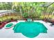 Aerial view of the sparkling pool and spa, surrounded by lush tropical landscaping and a screened enclosure at 7803 Mathern Ct, Lakewood Ranch, FL 34202