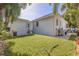 Spacious backyard with lush green lawn, mature trees, and a grill at 827 Placido Ne Way, St Petersburg, FL 33704