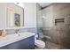 Modern bathroom features a gray tile shower and floating vanity at 827 Placido Ne Way, St Petersburg, FL 33704