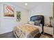 Cozy bedroom with a zebra-print bedspread, vibrant art, and natural light streaming through the window at 827 Placido Ne Way, St Petersburg, FL 33704