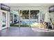 Home gym showcasing view to a luxurious outdoor pool and living area at 827 Placido Ne Way, St Petersburg, FL 33704