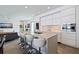 Modern kitchen featuring a large island with seating, white cabinets, and stainless appliances at 827 Placido Ne Way, St Petersburg, FL 33704