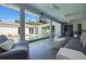 Covered outdoor living space with lounge seating, a TV, and a view of the pool at 827 Placido Ne Way, St Petersburg, FL 33704