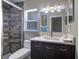 Bathroom showcasing tiled shower, ample vanity space, and natural lighting at 8289 136Th St, Seminole, FL 33776