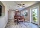 Dining area with wood table set, neutral paint, ample natural light, and patio door access at 8289 136Th St, Seminole, FL 33776