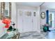 Welcoming entryway with natural light, decorative mirror, and a stylish front door at 8289 136Th St, Seminole, FL 33776