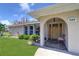 Charming front entrance featuring an arched entryway, stone pathway, and well-manicured landscaping at 8289 136Th St, Seminole, FL 33776