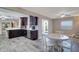 Open kitchen showcasing stainless appliances, wood cabinetry, and a breakfast table for casual dining at 8289 136Th St, Seminole, FL 33776