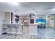 Open-concept living space with bar seating, pendant lighting, and a clear view to the living room at 8289 136Th St, Seminole, FL 33776