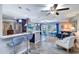 Bright living room featuring an open floor plan, kitchen bar seating, and comfortable furnishings at 8289 136Th St, Seminole, FL 33776