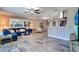 Open-concept living space with stylish furnishings, modern lighting, and easy access to the kitchen at 8289 136Th St, Seminole, FL 33776