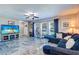 Bright living room featuring a comfortable blue sectional sofa, stylish decor, and large windows at 8289 136Th St, Seminole, FL 33776
