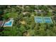 Aerial view of neighborhood amenities, including a pool, playground, tennis courts and recreational space at 852 Village Way, Palm Harbor, FL 34683