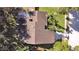 Aerial view shows roof, driveway, landscaping and proximity to surrounding trees at 852 Village Way, Palm Harbor, FL 34683