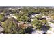 An aerial view showing a well-treed neighborhood with single-Gathering homes and mature landscaping at 852 Village Way, Palm Harbor, FL 34683