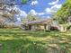This home offers a large backyard area with mature landscaping and a private outdoor space at 852 Village Way, Palm Harbor, FL 34683