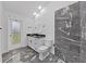 Updated bathroom featuring modern vanity with black countertop and black/gray tile shower at 852 Village Way, Palm Harbor, FL 34683
