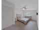 Bright bedroom features neutral walls, ceiling fan, dresser, and a comfortable-looking bed at 852 Village Way, Palm Harbor, FL 34683