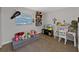 Bright and whimsical bedroom with seating area, desk, and toys; perfect for a or guest at 852 Village Way, Palm Harbor, FL 34683