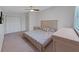Neutral bedroom with a bed, dresser, nightstand, and large closet, creating a calming atmosphere at 852 Village Way, Palm Harbor, FL 34683