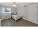 Clean bedroom featuring a ceiling fan, natural light, and a comfortable bed and nightstand at 852 Village Way, Palm Harbor, FL 34683