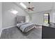 Bright bedroom featuring vaulted ceiling, skylights, ceiling fan, and a large upholstered headboard at 852 Village Way, Palm Harbor, FL 34683