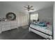 Cozy bedroom showcasing a dresser, mirror, closet, and a comfortable bed with a patterned comforter at 852 Village Way, Palm Harbor, FL 34683