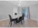 Bright dining room with chandelier, modern table set and sliding glass door to lanai at 852 Village Way, Palm Harbor, FL 34683