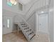 Bright entryway with tile floors, white staircase, and natural light at 852 Village Way, Palm Harbor, FL 34683