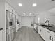 Open kitchen with stainless steel appliances, modern countertops, and plenty of cabinet space at 852 Village Way, Palm Harbor, FL 34683